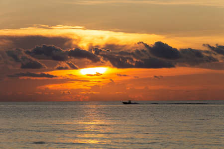 The boat speeds against the backdrop of a beautiful sunset at sunset Miamiの写真素材