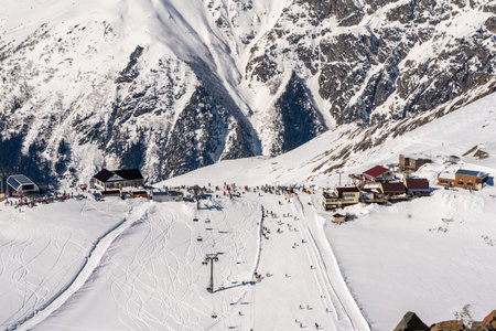 Panorama of winter snowy mountains in Caucasus region in Russia with ski lift and ski track