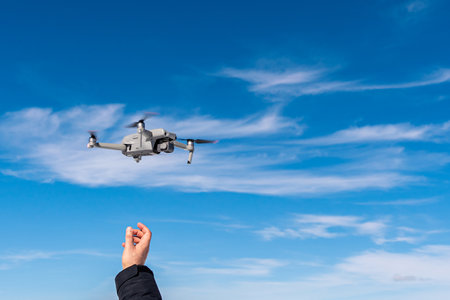 the drone takes off from the hands of the operatorの写真素材