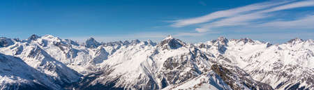 Panoramic view of winter snowy mountains in Caucasus region in Russia with blue skyの写真素材