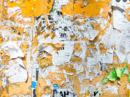 Yellow Old Billboard With Torn Posters And Ads Backgroundの写真素材