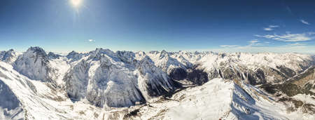 view of snowy mountains and sunの写真素材
