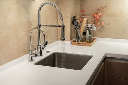Minimalist kitchen with white countertop and sinkの写真素材