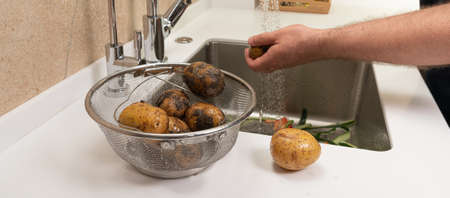 Basket of dirty potatoes for cooking dinner before washingの写真素材