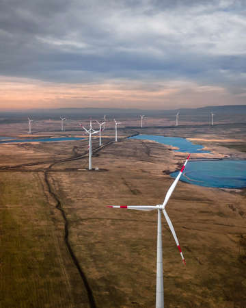 Wind turbine farm at sunset. Renewable energy conceptの写真素材