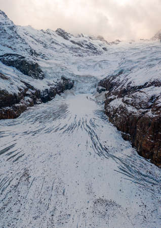 Scenic View Of Snow Covered Mountains with old moving glacier. Icefield high up in the mountainsの写真素材