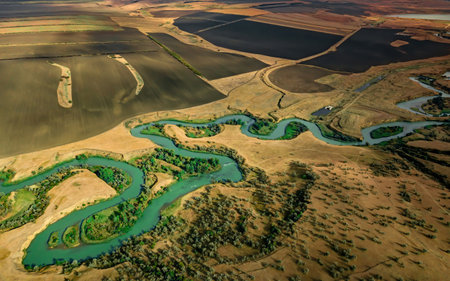 Summer scenery aerial view of winding river in beautiful valley at sunsetの写真素材