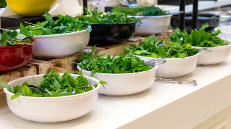 Salad bar with fresh greens in hotel buffet. Concept of healthy eatingの写真素材