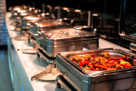 Breakfast and lunch buffet food catering banquet in hotel. Heated buffet container with meat and pepperの写真素材