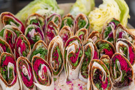 Wrap sandwich, many rolls with fresh vegetables on a plateの写真素材