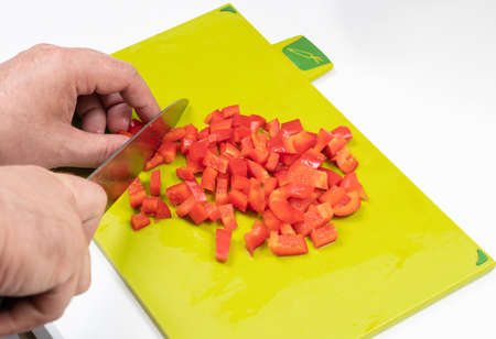 preparation of bell pepper salad by mens handsの写真素材