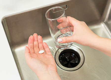 close-up of a pill in a womans hand for a headacheの写真素材