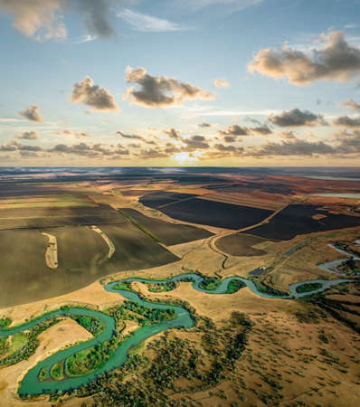 Summer scenery aerial view of winding river in beautiful valley at sunsetの写真素材