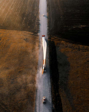 Turbine bladesfor a wind turbine being transported to the construction site by truckの写真素材