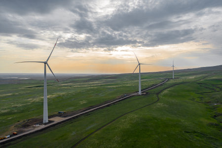 Wind turbine farm at sunset with dramatic sky. Producing alernative energy. Renewable energy concept.の写真素材