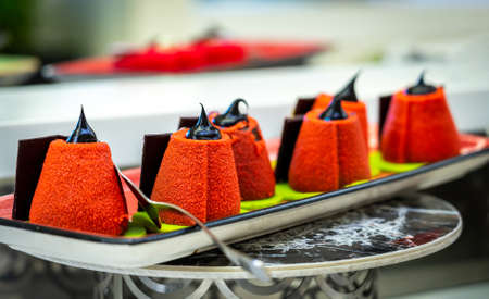 small cakes chocolate roll covered with sugar on a plate in a restaurantの写真素材
