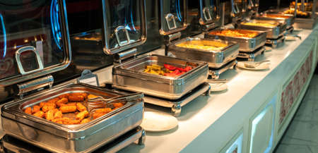 Heated buffet containers with potato sticks for breakfast in hotel restaurantの写真素材