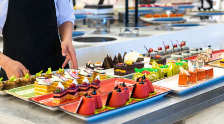 The chef decorates cakes in the hotel barの写真素材