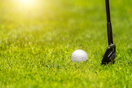 Golf iron club ready to hit a ball on green grass on golf courseの写真素材