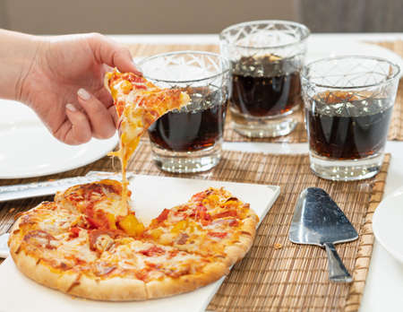 dinner for three close-up homemade pizza and cokeの写真素材