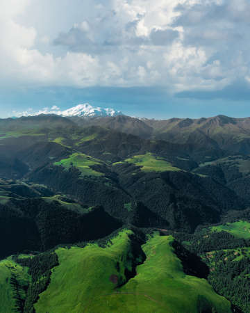 A river flowing through a mountain valley dividing it into two partsの写真素材