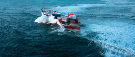 Stormy sea with Container ship delivering cargo at sunsetの写真素材