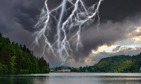 Several lightning bolts over the city standing on the lakeの写真素材
