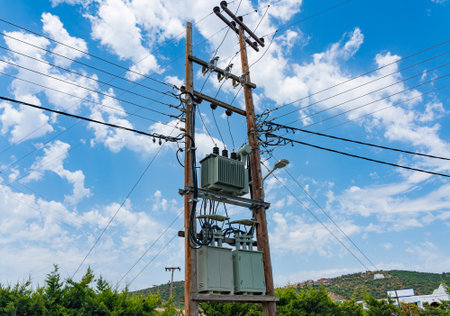 Electrical transformer mounted on a street pole against the skyの写真素材
