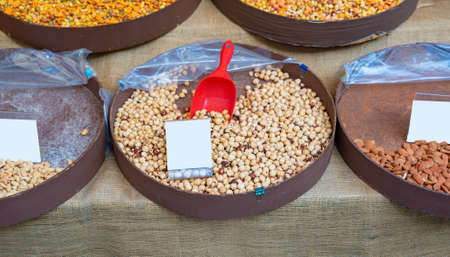 Peeled hazelnuts on a market stall in yellow tones close-upの写真素材