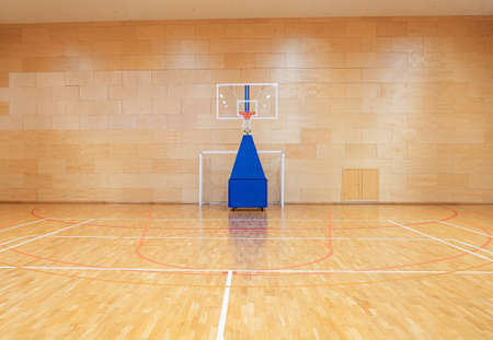 Handball goal and movable basketball basket in the gymの写真素材