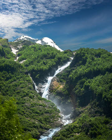 Beautifull high waterfall in mountains with green forestの写真素材