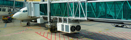 Airplane at the retractable gangway at the airportの写真素材