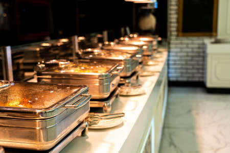 Many buffet heated trays ready for service in hotel restaurantの写真素材