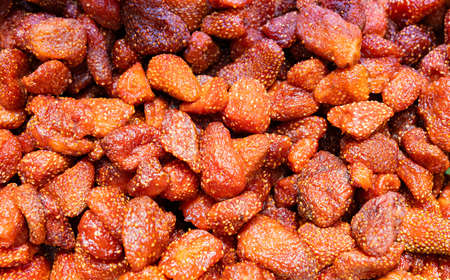 Dried strawberry pieces in bright red sugarの写真素材