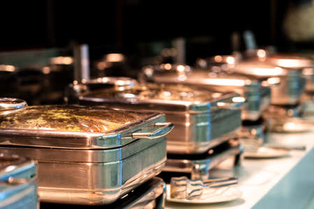 Many buffet heated trays ready for service in hotel restaurantの写真素材
