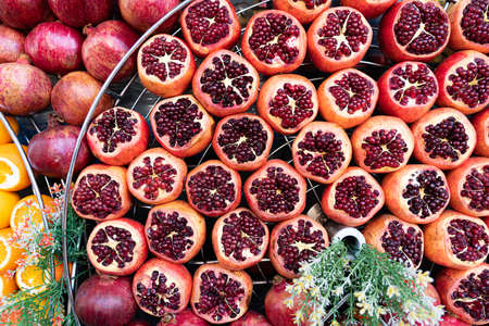 Rows of ripe pomegranates cut on one sideの写真素材