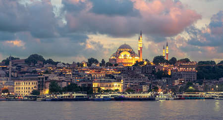 Suleymaniye Mosque with night illumination and minaret of Rustem Pasha Mosque, Istanbul, Turkeyの写真素材