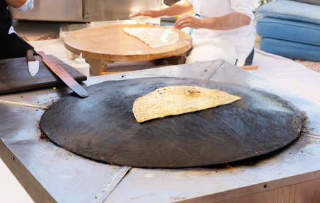 Close-up of traditional oriental flatbread cooking on the stoveの写真素材