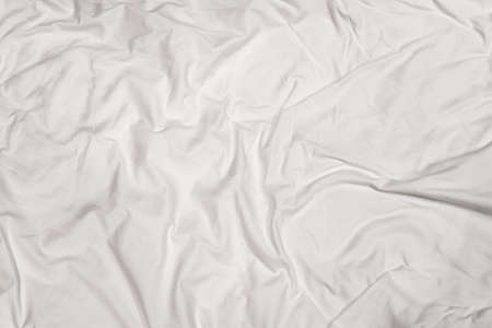 Closeup texture of crumpled white bed sheet with messy abstract patternの写真素材