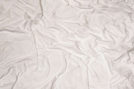 Crumpled white sheet texture with messy abstract patternの写真素材