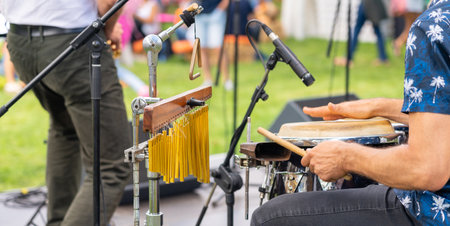 Playing a drummer at a street festival as part of a musical groupの写真素材