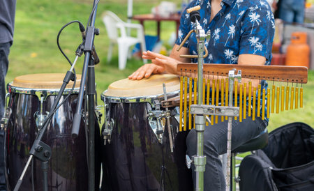 Street folk festival drummer playing drums with his hands on the stage close-upの写真素材