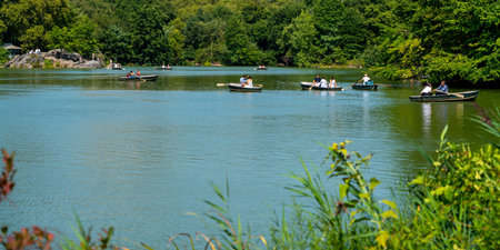 New York City, United States - September 19, 2022 Central Park Lake. People are rowing boatsのeditorial素材