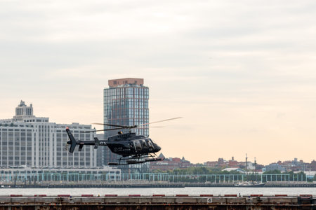 New York City, United States - September 19, 2022 A helicopter lands on the East River Manhattan heliport to take passengers for a rideのeditorial素材