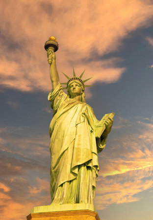 Statue of Liberty at sunrise in golden tones front viewの写真素材
