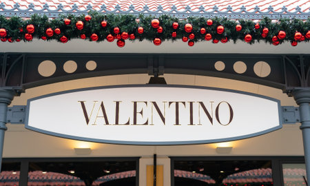 Vienna, Austria - December 10, 2022: Valentino store showcase with golden letters and Christmas decorationsのeditorial素材