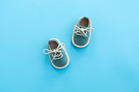 Baby shoes on paper background with copy space. Baby clothes concept. Top view, flat layの写真素材