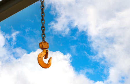 Not very new construction crane hook against a cloudy skyの写真素材