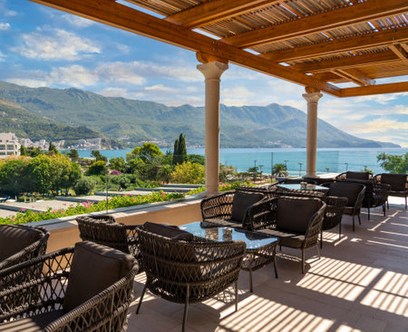 Wicker chairs and tables on the outdoor terrace of the hotel restaurantの写真素材