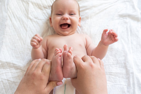 Playful interactions with babys small feet. Concept of the joys of motherhoodの写真素材